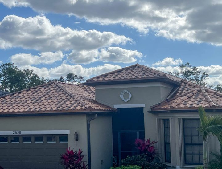 A close-up of a residential home featuring a traditional clay tile roof, showcasing its durability and classic aesthetic.